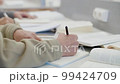 Unrecognizable senior man writing outline in notebook  99424709