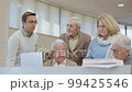 Senior people trying to solve task during class in library 99425546