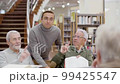 Senior people having debate during class in library 99425547