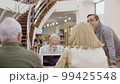 Old people talking with teacher during class in library 99425548