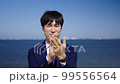 海で拍手するビジネスマン 99556564