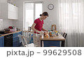 A young girl cooks in a spacious kitchen 99629508