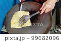 Roti which are cooking on the hot pan, small business 99682096