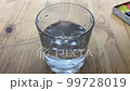 A hand dips a brush with paint into a glass. In the video, a hand dunks a brush with  blue paint into a glass. 99728019