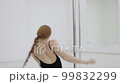 Seductive female doing pole dance in studio 99832299