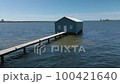 Aerial rising orbit shot of blue boat house in Perth, Australia 100421640