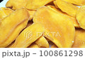 dried mango close-up. yellow pieces of manga close-up moves in a circle 100861298