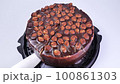 cutting chocolate cake with a knife close-up 100861303