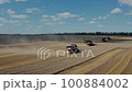 Harvester Harvests Wheat Crop On Field 100884002
