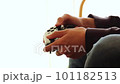 Boy's hand operating the game controller 101182513