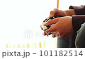 Boy's hand operating the game controller 101182514