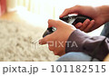 Boy's hand operating the game controller 101182515