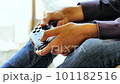 Boy's hand operating the game controller 101182516