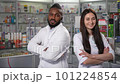 In this 4K high-quality footage, a black middle-aged male and young female pharmacy professionals smile for a portrait. The video highlights the work of drugstore staff in healthcare and medicine  101224854