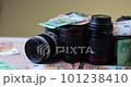 Camera equipment covered in paper money bills, grey Mellow Yellow Background 101238410