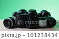Looking at expensive aesthetic camera equipment on green background studio room 101238434