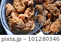 Selective fokus crispy fried chicken parts in a colander. Crispy, deep-fried chicken in colander, street food in Indonesia. 101280346