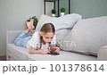 Child play with a mobile phone at home. 101378614