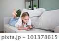 The child plays with a mobile phone at home and gets angry. 101378615