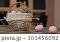 Adorable beige bunny sitting calmly in a basket. Easter mood. Close-up 101456092