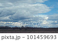Time lapse with white cumulus clouds over a green field in countryside in autumn, winter or early spring 101459693