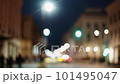 Bokeh city life, cityscape blurred background, urban street illuminated in evening. Yellow bus public transport and people pedestrians walking in slow motion. Downtown cityscape, night illumination 101495047
