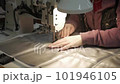 Fabric for furniture upholstery. woman's hands at the sewing machine 101946105