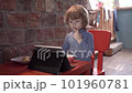 a little boy is looking at the tablet with interest 101960781