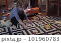 A little boy is playing with toys in the room 101960783