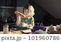 A little boy cuts an carrot in the kitchen 101960786