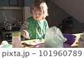 A little boy cuts an onion in the kitchen 101960789