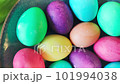 Colorful dyed Easter eggs in bowl with tulip flowers around. High quality 4k footage 101994038