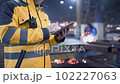 Engineer in hard hat is moving through a heavy industry factory with a tablet computer. Slow-Motion. 102227063