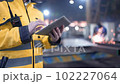 A male process engineer works on a personal computer. Portrait of a professional heavy industry engineer. Building under construction. Safety glasses and hard hat. FullHD slow motion 102227064