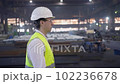 A male process engineer works on a personal computer. Portrait of a professional heavy industry engineer. Building under construction. Safety glasses and hard hat. FullHD slow motion 102236678