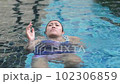 Young Asian woman drowning due to leg cramp in swimming pool area 102306859