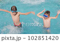 Happy children pool fun splash water happy summer kids splashing in pool kids holiday summer travel fun boy. Cheerful children swimming pool playing water kids swimming boy water fun summer vacation 102851420