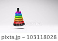 Colorful Rings Toy Spinning on Studio Light Gray Background 103118028