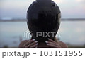 A girl in a motorcycle helmet Portrait of a fabulous Slavic young woman in a motorcycle helmet looking into the camera. Close-up 103151955