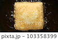 Top view of fried tofu in boiling oil. vegan and vegetarian food  103358399