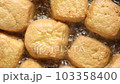 Top view of fried tofu puffs in boiling oil. vegan and vegetarian food  103358400
