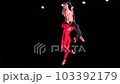 Circus aerial hoop duo on black background performing risky tricks. Man and women fly on stage 103392179