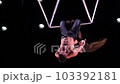 Circus aerial cube duo on black background performing tricks in slow motion. Man and women fly on stage 103392181