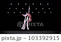 Aerial silk duo in white costumes on black background doing performance. Concept of romantic relation ship in couple  103392915