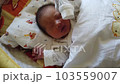 newborn sleeping in crib 103559007