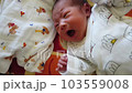 newborn sleeping in crib 103559008