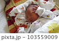newborn sleeping in crib 103559009