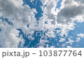 Low Angle view TimeLapse of direct bright noon sun on blue sky with clouds 103877764