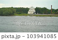Church on the background of the river. A spring landscape of a swollen river, with a church in the background. 103941085