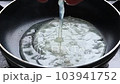 Cracked raw chicken egg into hot frying pan 103941752